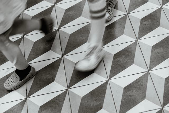 People walking on a geometric-patterned floor
